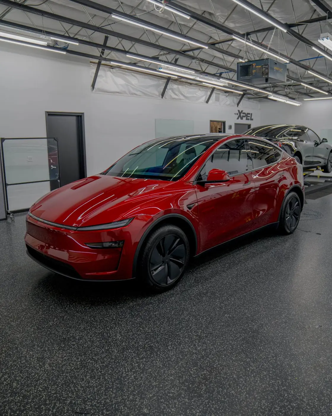 Red Tesla Model Y in the Apex Films shop in Fresno