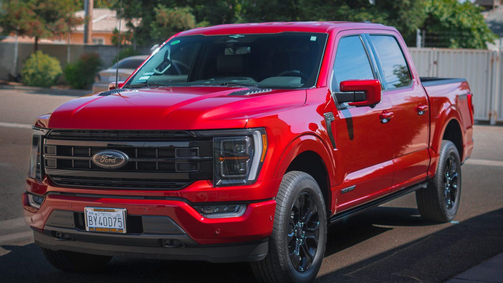 Red Ford truck parked on a sunny street