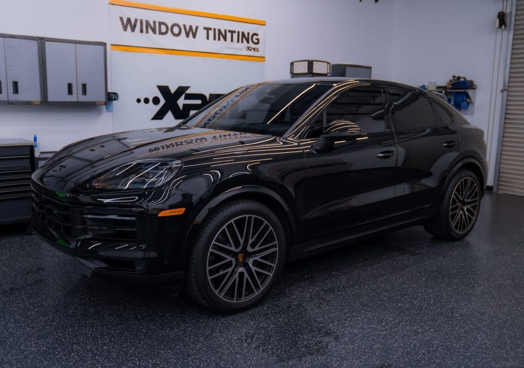 Black luxury SUV with window tint in a service shop
