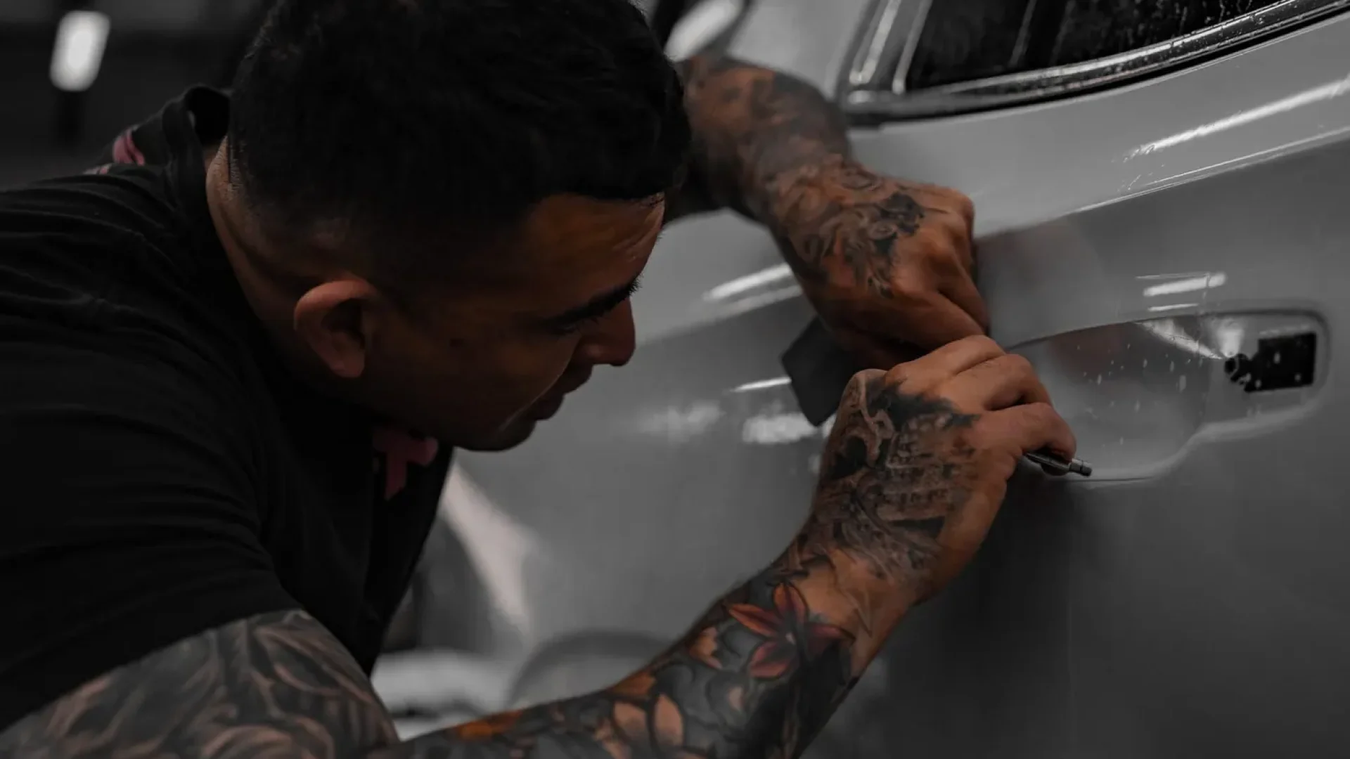 Apex Films installer applying XPEL film to a car door